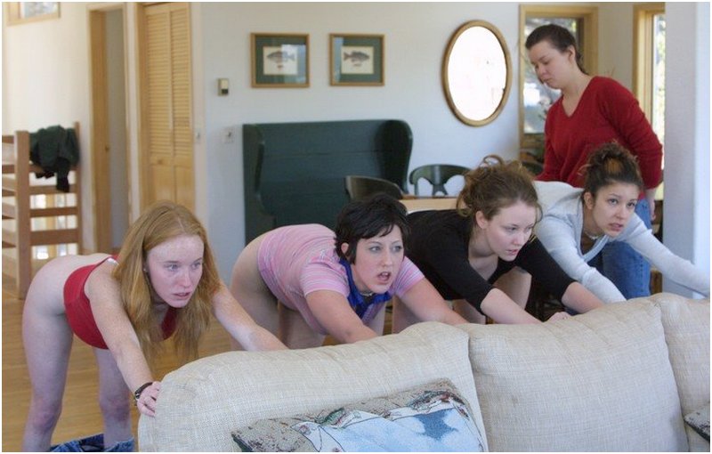 four punished girls bending over a couch for spanking